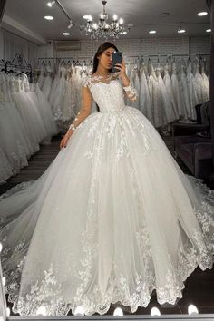 a woman is taking a selfie in her wedding dress while looking into the mirror