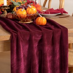 the table is set with pumpkins and other decorations