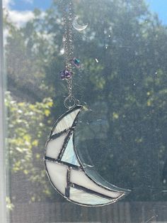 a stained glass sun catcher hanging from a window