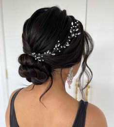 a woman with black hair wearing a bridal headpiece