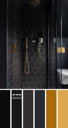 a bathroom with black walls and gold accents, including the shower head in the corner