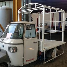 a small white truck parked in a garage