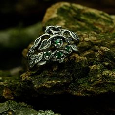 This unique bridal set features a Sterling Silver Engagement Ring and a stackable Forest Theme Wedding Band, creating a whimsical and enchanting look inspired by nature. It's the perfect choice for those who appreciate the beauty of the outdoors and want a meaningful and unique symbol of their love.  Characteristics: Metal - Recycled solid sterling silver  Stone - Cubic Zirconia: shevron ring - 1 pc. - 2.5 mm, 2 pcs. - 1.75 mm, mushroom ring - 2.5 mm Finish - Oxidized. View all silver nature rin Wishbone Ring Stack, Wedding Ring With Emerald, Mushroom Rings, Mushroom Wedding, Wedding Band Stack, Nature Inspired Wedding Bands, Dinosaur Wedding, Nature Fairy, Forest Theme Wedding