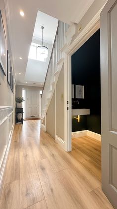 an empty hallway with stairs leading up to the second floor