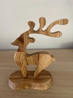 a wooden deer sculpture sitting on top of a table