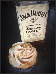 a cupcake next to a bottle of jack daniels honey