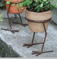 two potted plants sitting on top of each other next to each other with legs