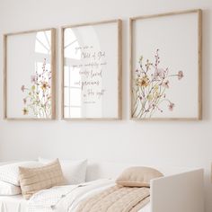 two framed pictures hanging on the wall above a bed