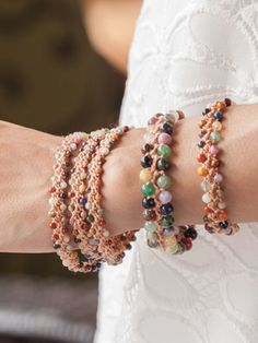 a close up of a person wearing bracelets with beads on their wrist and arm