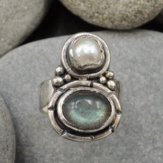 "Here's a Labradorite and freshwater Pearl ring. This double stone piece is a timeless ring. It could come from the Roman past, or a contemporary jewelry of our time , where many cultures and differents times coexist. It encloses this two stones and together form an incredible combination. Its shape is wide in front, narrow and adjustable behind, making it a very comfortable ring to wear. This is a piece for natural stones lovers, beautiful and unique , perfect for your every day life and even o Hippies, Raw Jewelry, Silver Pearl Ring, October 4th, I'm Leaving, Timeless Ring, Freshwater Pearl Ring, Artisan Rings, Witch Jewelry