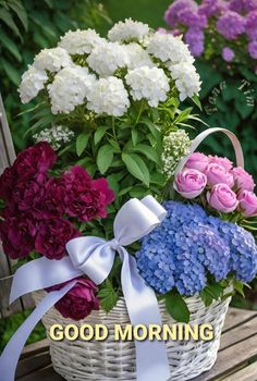 a basket filled with lots of flowers sitting on top of a wooden bench next to purple and white flowers