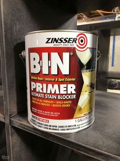 a can of bin primer sitting on top of a shelf