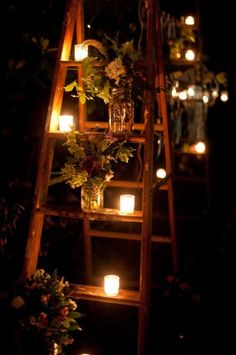 a ladder with candles and flowers on it in front of a screen shot from the web