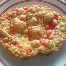 a piece of pie on a plate with red and white trim around it, sitting on a table