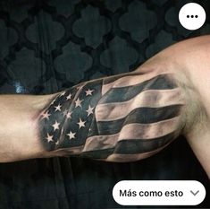 an american flag tattooed on the arm of a man's left arm and chest