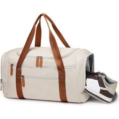 Introducing the elegant canvas duffle bag, perfect for your gym sessions and travel adventures. Crafted with durable materials and designed for practicality, this bag combines style and functionality effortlessly. Features: Material: Made from high-quality canvas with leather accents, ensuring durability and a sophisticated look. Design: Features a classic design with dual-tone handles and multiple compartments, including a side shoe pocket. Special Features: Includes a dedicated shoe compartmen Casual Canvas Gym Bag With Large Capacity, Casual Large Capacity Canvas Gym Bag, Functional Canvas Satchel With Canvas Lining, Sporty Canvas Bag With Zipper Closure, Large Capacity Sporty Canvas Bags, Functional Canvas Shoulder Bag For Overnight Trips, Sporty Canvas Bag With Large Capacity, Casual Large Capacity Duffle Bag For Overnight Trips, Functional Weekender Bag With Leather Trim