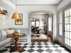 a dining room with a checkered floor and white walls