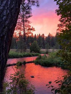 the sun is setting over a small river