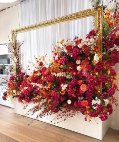 flowers are arranged on the wall in front of a mirror