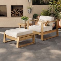 a chair and ottoman sitting on a patio with potted plants in the back ground