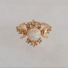 Gold Plated, White Opal (Simulated) Celestial Ring. Features The “Sun”, “Moon”, And “Stars” Represented By The Different Stones. Item Is A Size 6, New, And Unworn. Please Ask Me Any Questions You May Have Prior To Making A Purchase. Sun Moon Engagement Ring, Sun And Moon Wedding Rings, Celestial Engagement Ring, Proposal Rings, Sun Ring, Sun Moon And Stars, Celestial Ring, Cz Wedding Rings, White Opal Ring