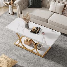 a white marble coffee table with gold accents