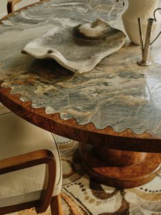 a marble topped table with chairs around it