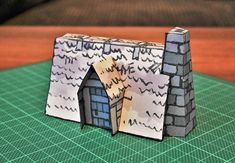 a paper model of a house on a table