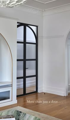 an empty living room with white walls and wood floors