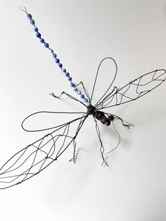 an insect made out of wire and beads