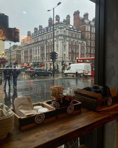 a window with some items on it in front of a street and people walking down the sidewalk