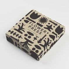 a box with black and white designs on the front, sitting on a white surface