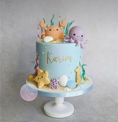 a blue cake decorated with an octopus and sea animals