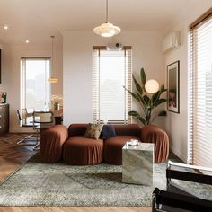 a living room filled with furniture next to a window covered in shades of brown and white