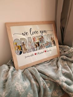 a wooden framed sign that says we love you grandma on it sitting on a bed