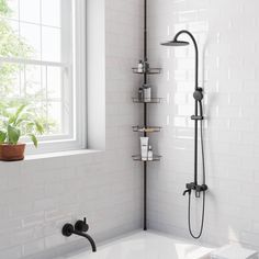 a bathroom with a tub, shower head and window