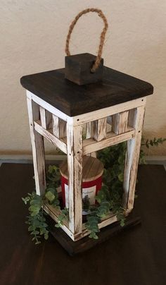 a small wooden lantern sitting on top of a table