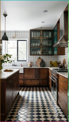 a kitchen with black and white checkered flooring, wooden cabinets and an oven