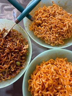 three bowls filled with different types of noodles