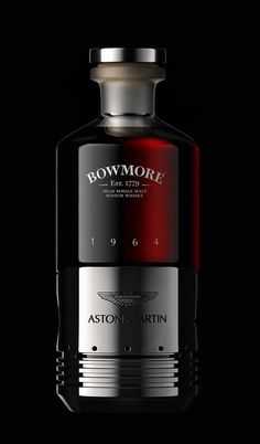 a bottle of bowmore's aston martin whisky on a black background with the label in red