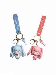 two key chains with cartoon characters attached to them, one is pink and the other is blue