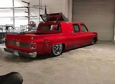 a red pick up truck parked in a garage