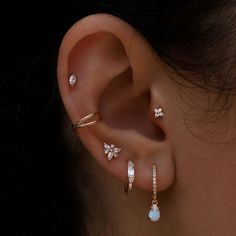 a close up of a person's ear with three different types of piercings