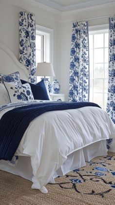 a bedroom with blue and white decor in it