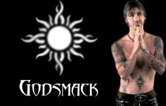 a shirtless man with tattoos standing in front of a black background and the words godsmack