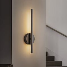 a wall light that is next to some stairs