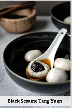 black sesame tang yuen in a bowl with a spoon