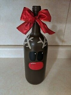 a brown bottle with a red bow and reindeer face on it's head is sitting on a counter