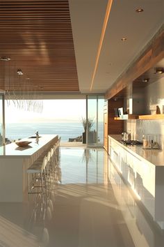 a modern kitchen with an ocean view is shown