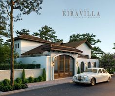 a white car is parked in front of a house with trees and bushes around it